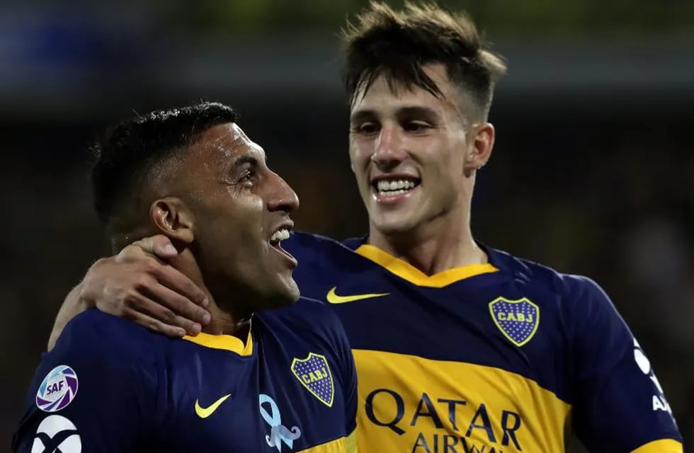 Boca Juniors' forward Ramon Abila (L) celebrates with his teammate  midfielder Nicolas Capaldo after scoring a goal against Argentinos Juniors during their Argentina First Divison 2019 Superliga Tournament football match at La Bomboneral stadium, in Buenos Aires, on November 30, 2019. (Photo by ALEJANDRO PAGNI / AFP)
