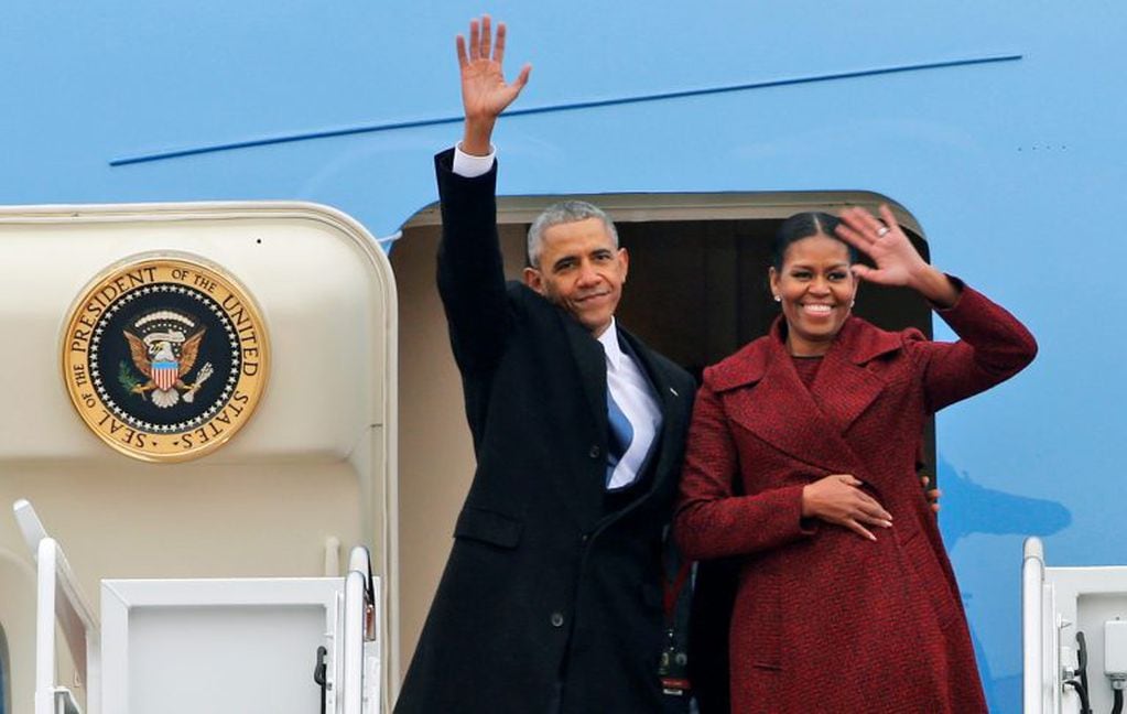 Former President Barack Obama and his wife Michelle wave to the crowd as they board an Air Force jet to depart Andrews Air Force base in Andrews Air Force Base, Md., Friday, Jan. 20, 2017. (AP Photo/Steve Helber)