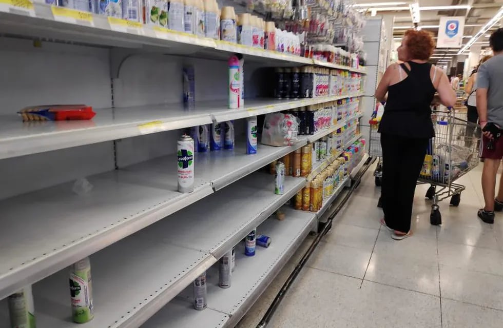 Shoppers browse near-empty shelves at a supermarket in Buenos Aires, as people hoard cleaning products due to the coronavirus outbreak, in Buenos Aires, Argentina March 13, 2020. REUTERS/Agustin Marcarian