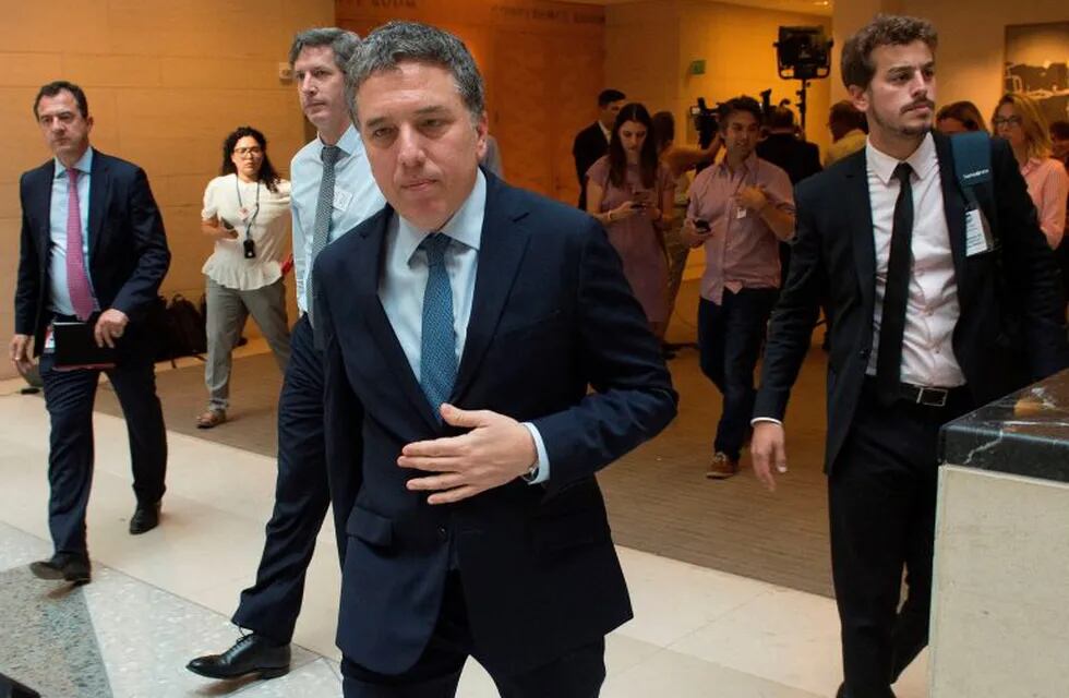 Argentina's Economy Minister Nicolas Dujovne walks with staff after speaking to the press after talks with the International Monetary Fund (IMF) in Washington, DC, on September 5, 2018. (Photo by ANDREW CABALLERO-REYNOLDS / AFP)