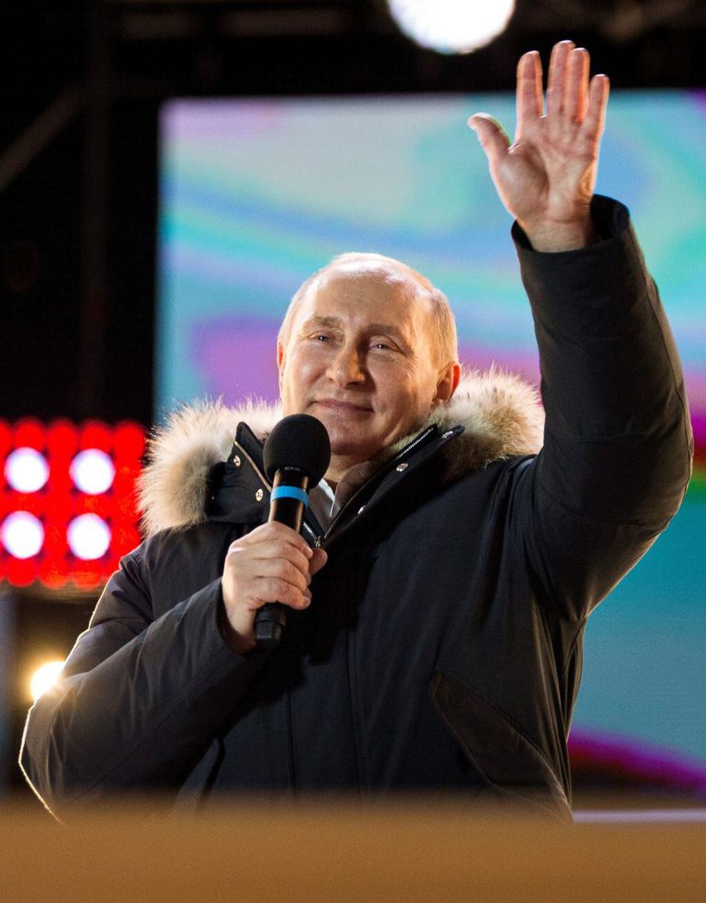 Russian President Vladimir Putin waves after speaking to supporters during a rally near the Kremlin in Moscow, Sunday, March 18, 2018. Vladimir Putin headed to an overwhelming win in Russia's presidential election Sunday, adding six years in the Kremlin for the man who has led the world's largest country for all of the 21st century. (AP Photo/Alexander Zemlianichenko)