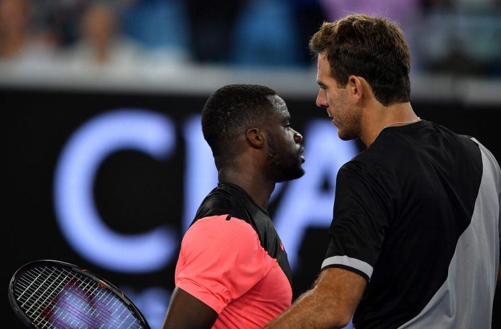 Argentina's Juan Martin del Potro (R) embraces after victory in his men's singles first round match against Frances Tiafoe of the US on day two of the Australian Open tennis tournament in Melbourne on January 16, 2018. / AFP PHOTO / Greg Wood / -- IMAGE RESTRICTED TO EDITORIAL USE - STRICTLY NO COMMERCIAL USE --