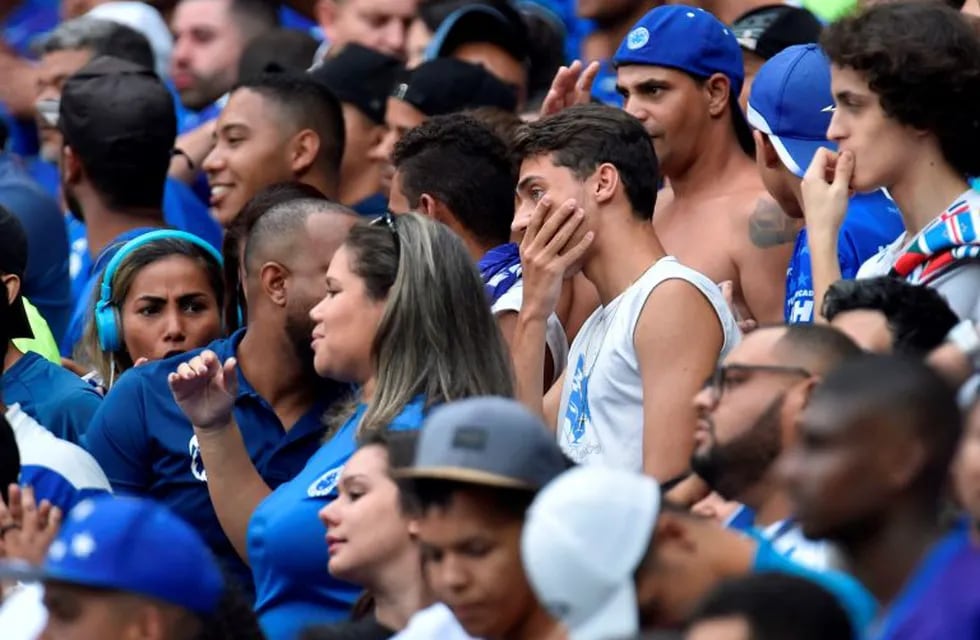 Fans of Cruzeiro react during the Brazilian Championship football match against Palmeiras, in Belo Horizonte, Brazil, on December 8, 2019. - Cruzeiro, one of the great clubs in Brazil, reached the last day of the Brasileirao in the relegation zone and does not depend on itself to remain in the elite of Brazilian football. (Photo by DOUGLAS MAGNO / AFP)
