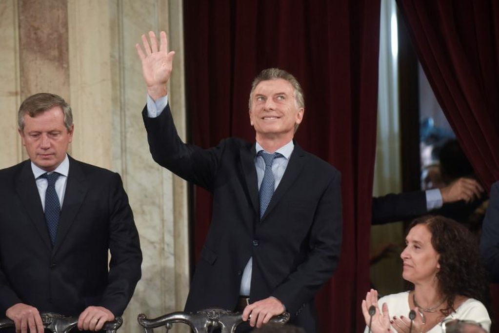 Argentina's President Mauricio Macri waves as he arrives to open the 2018 session of Congress and give the annual State of the Nation address, flanked by Emilio Monzo, president of the Chamber of Deputies, left, and Vice President Gabriela Michetti, in Buenos Aires, Argentina, Thursday, March 1, 2018. (AP Photo/Pablo Stefanec)