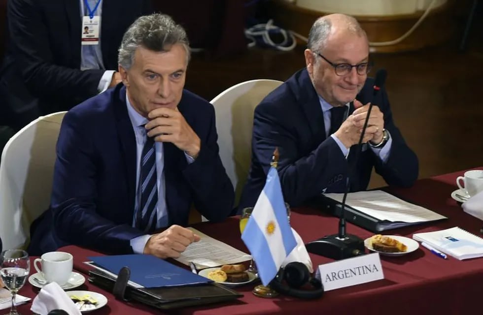 CORRECTION - Argentina's President Mauricio Macri (L) and his Foreign Affairs Minister Jorge Faurie, attend the Mercosur President's Summit in Montevideo on December 18, 2018. - Partner countries presidents and Mercosur's associated states kick off a summit meeting in Montevideo on Tuesday aiming to initiate a reform of the bloc. (Photo by MIGUEL ROJO / AFP) / “The erroneous mention[s] appearing in the metadata of this photo by MIGUEL ROJO has been modified in AFP systems in the following manner: [on December 18, 2018.] instead of [December 17, 2018.]. Please immediately remove the erroneous mention[s] from all your online services and delete it (them) from your servers. If you have been authorized by AFP to distribute it (them) to third parties, please ensure that the same actions are carried out by them. Failure to promptly comply with these instructions will entail liability on your part for any continued or post notification usage. Therefore we thank you very much for all your atte uruguay montevideo mauricio macri cumbre del mercosur en montevideo argentina asume presidencia del mercosur