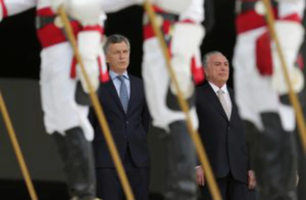 Argentina's President Mauricio Macri, left, stands next to Brazil's President Michel Temer during during a welcoming ceremony at the Planalto Presidential Palace, in Brasilia, Brazil, Tuesday, Feb. 7, 2017. Macri is one day official visit to Brazil. (AP P