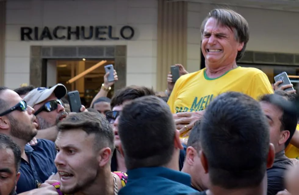 CORRECTS MONTH - In this handout photo provided by the National Social Liberal Party press office, presidential candidate Jair Bolsonaro poses for a photo while sitting in his hospital room at the Albert Einstein Hospital, in Sao Paulo, Brazil, Saturday, Sept. 8, 2018. The far-right congressman was stabbed on Thursday during a campaign rally. Bolsonaro, 63, suffered intestinal damage and serious internal bleeding, according to Dr. Luiz Henrique Borsato, one of the surgeons who operated on the candidate. (Flavio Bolsonaro/National Social Liberal Party via AP)