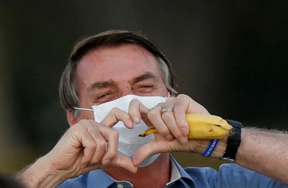 Brazil's President Jair Bolsonaro gestures while meeting supporters during a ceremony of lowering the national flag for the night, amid the coronavirus disease (COVID-19) outbreak, at the Alvorada Palace in Brasilia, Brazil, July 24, 2020. REUTERS/Adriano Machado     TPX IMAGES OF THE DAY