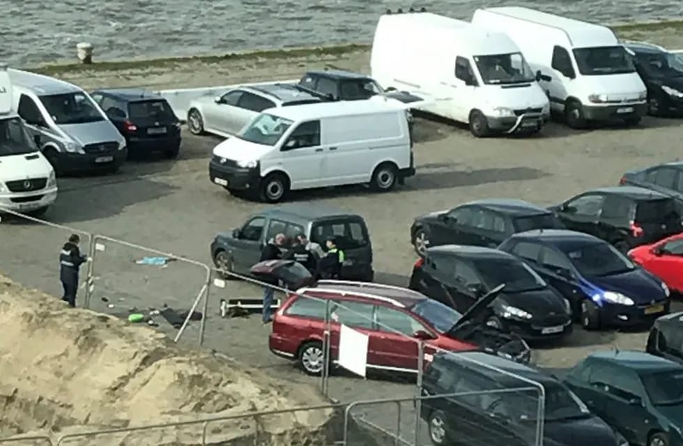 A picture obtained from the Twitter account of Anouk Leemans shows police standing next to a car after a man tried to drive into a crowd at high-speed in a shopping area in the port city of Antwerp, on March 23, 2017.nBelgian security forces arrested the 