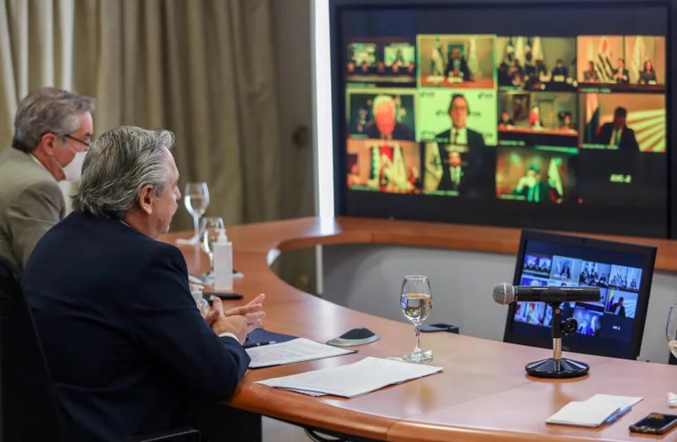Handout picture released by Argentina's Presidency showing Argentine President Alberto Fernandez (R) and his Foreign Minister Felipe Sola taking part in the first Mercosur Summit held via video conference due to the COVID-19 novel coronavirus pandemic, from Olivos Presidential Residence in Olivos, Buenos Aires, on July 2, 2020. - The leaders of the South American trade bloc Southern Common Market, the presidents of Argentina, Alberto Fernandez; from Brazil, Jair Bolsonaro; from Paraguay, Mario Abdo; and from Uruguay, Luis Lacalle, intend to put aside their political differences and focus on strengthening new markets for their exports, mainly agricultural. (Photo by ESTEBAN COLLAZO / Argentinian Presidency / AFP) / RESTRICTED TO EDITORIAL USE - MANDATORY CREDIT \