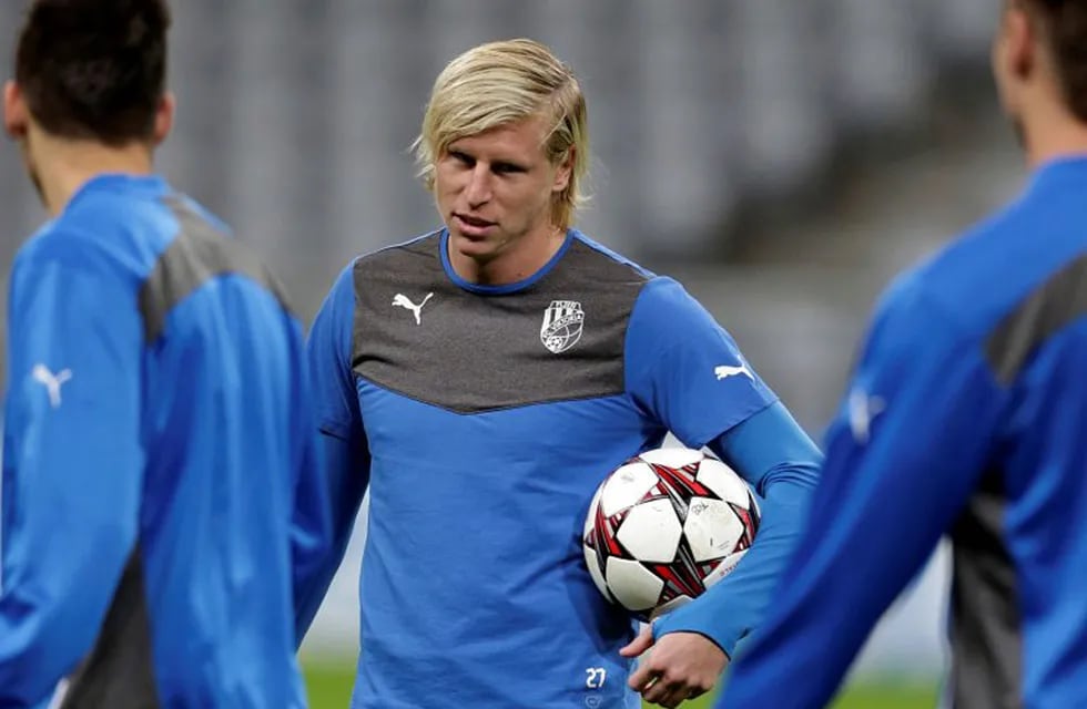 FILE - In this Tuesday, Oct. 22, 2013 file photo, Plzen's Frantisek Rajtoral holds a ball during a training session in Munich, southern Germany. Former Czech Republic defender Frantisek Rajtoral, who won the domestic league title four times before joining