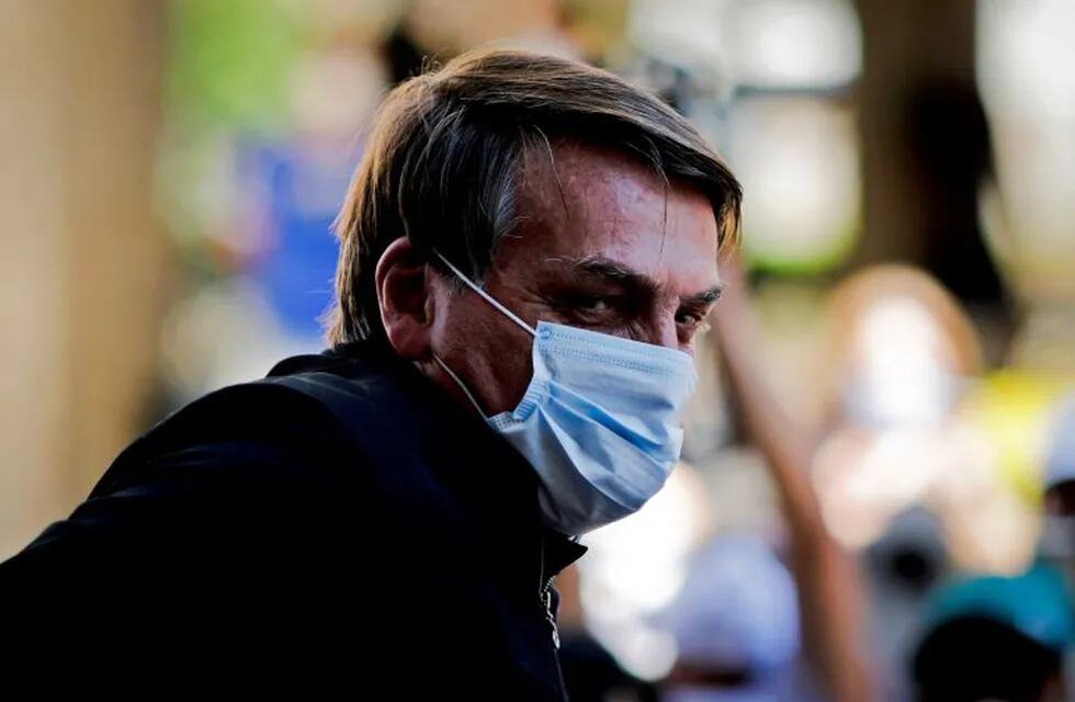 Brazilian President Jair Bolsonaro is seen as he visits the residence of an adviser in Brasília, on August 23, 2020. - Bolsonaro on Sunday threatened to punch a reporter repeatedly in the mouth after being asked about his wife's links to an alleged corruption scheme. \