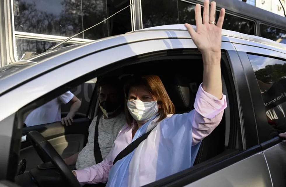 Argentinian former Security Minister Patricia Bullrich waves from a car as she takes part in a protest against the government of Argentina's President Alberto Fernandez at Plaza de la Republica square in Buenos Aires on October 12, 2020, amid a lockdown against the spread of the COVID-19 coronavirus. (Photo by JUAN MABROMATA / AFP)