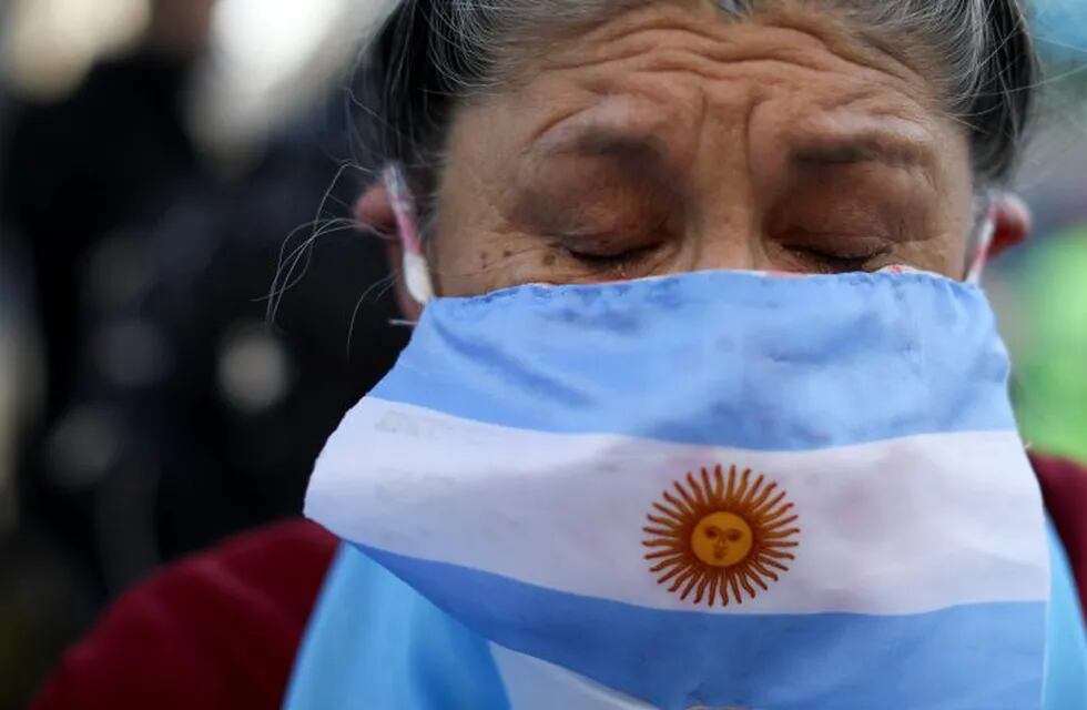 A protester wearing an Argentine flag as a mask cries as he demands the end of the government-ordered lockdown to curb the spread of the new coronavirus in Buenos Aires, Argentina, Thursday, July 9, 2020. People protested across the country during the local Independence Day holiday, the handling of the pandemic by the administration of President Alberto Fernandez. (AP Photo/Natacha Pisarenko)