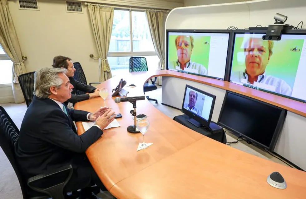 Handout picture released by the Argentine presidency showing Argentina's President Alberto Fernandez (L) and his Secretary of Strategic Affairs Secretary Gustavo Beliz holding a video conference with the World Bank Managing Director of Operations Axel van Trotsenburg, from the presidential residence in Olivos, Buenos Aires, on March 25, 2020. - The World Bank approved a loan of 300 million US dollars in budgetary support for Argentina to strengthen the social protection system and minimize the impact of the COVID-19 crisis on the most vulnerable sectors. It aims to strengthen the National Social Security Administration's (ANSES) Child and Youth Protection Project. (Photo by Esteban COLLAZO / Argentinian Presidency / AFP) / RESTRICTED TO EDITORIAL USE - MANDATORY CREDIT \
