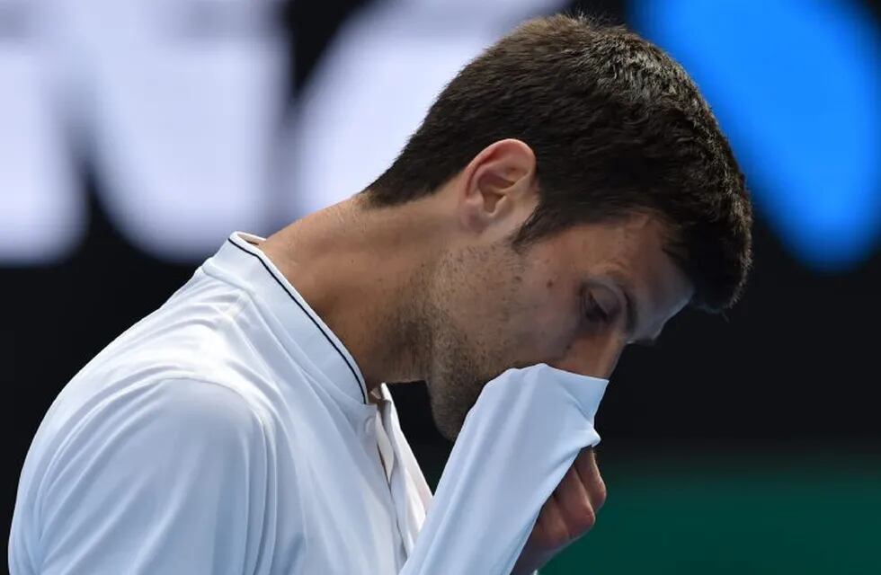 TOPSHOT - Serbia's Novak Djokovic reacts after a point against Uzbekistan's Denis Istomin during their men's singles match on day four of the Australian Open tennis tournament in Melbourne on January 19, 2017. / AFP PHOTO / PAUL CROCK / IMAGE RESTRICTED T