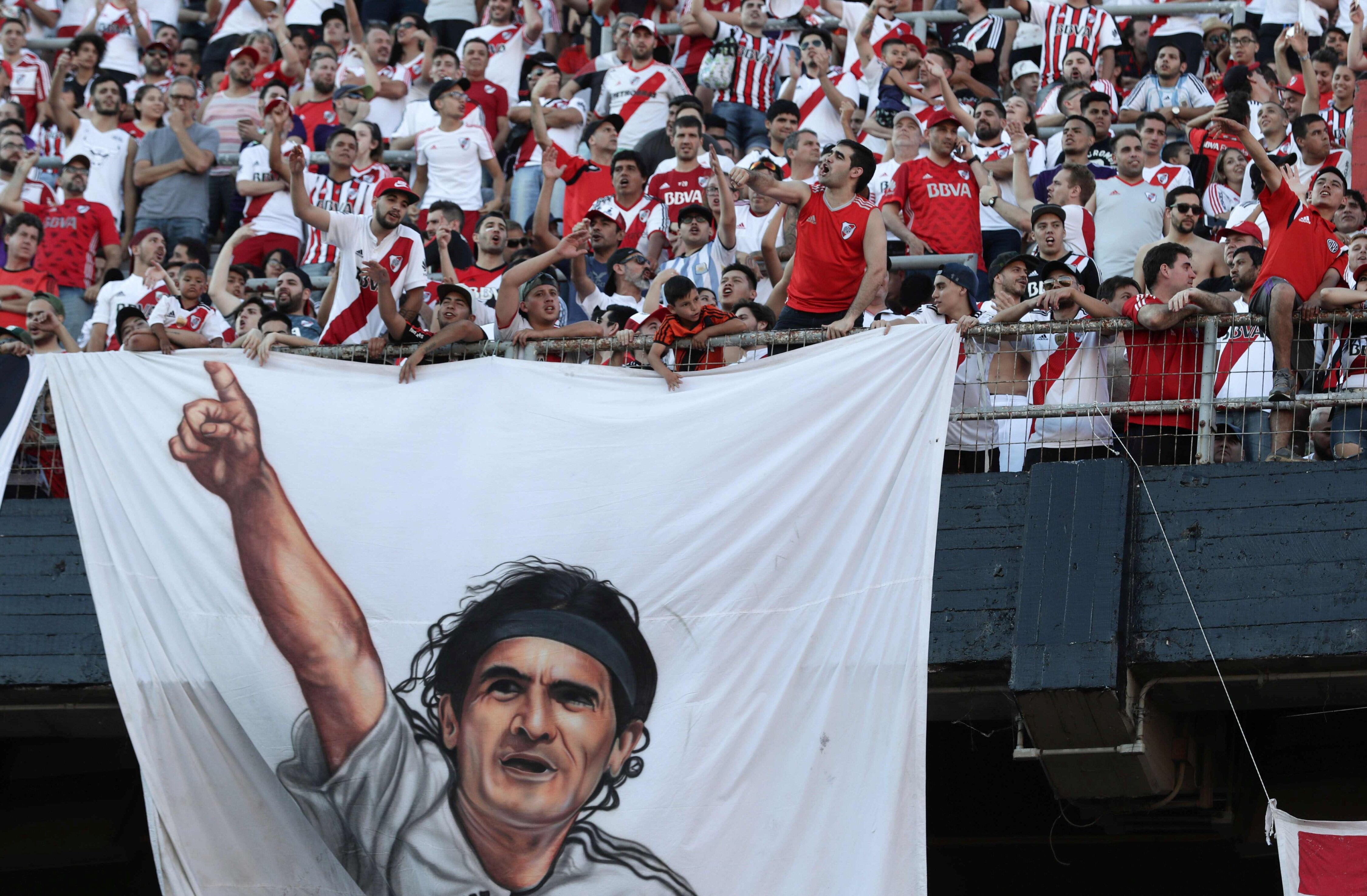 Fanáticos de River Plate sostienen una bandera que representa al legendario exjugador Ariel Ortega, en el estadio Monumental de Buenos Aires el 23 de diciembre de 2018, para celebrar el triunfo de su equipo en la final argentina de la Copa Libertadores, luego de vencer a su archirrival Boca Juniors por 3-1 en Madrid el 9 de diciembre de 2018. Los integrantes de River Plate llegaron a Argentina luego de participar en el Mundial de Clubes de la FIFA en los Emiratos Árabes Unidos y obtener el tercer lugar.