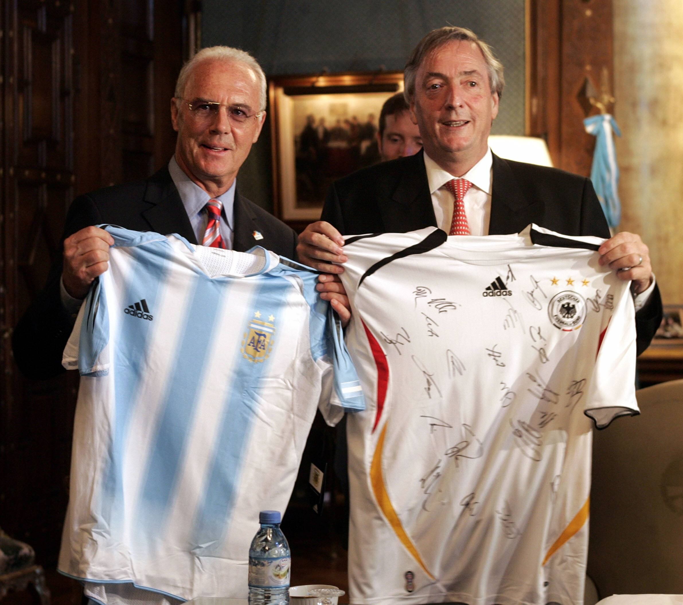 el presidente argentino Néstor Kirchner  y el alemán franz beckenbauer  presidente del comité organizador de la copa del mundo, intercambian camisetas de los seleccionados de futbol de sus pases