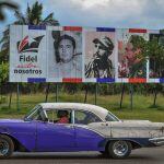 TOPSHOT - An old car drives past a billboard depicting Cuban revolutionary leader Fidel Castro and reading "Fidel Among Us," in Havana, on November 27, 2016 two days after his death.
Cuban revolutionary icon Fidel Castro died late November 25 in Havana, h