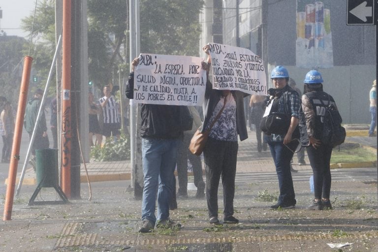 BH16. SANTIAGO (CHILE), 16/01/2018.- Jóvenes protestan por la llegada del papa Francisco hoy, martes 16 de enero de 2018, por las calles de Santiago (Chile). La policía disolvió hoy en Santiago la "Marcha de los Pobres", convocada por varias organizaciones sociales en protesta contra la visita del papa Francisco a Chile, según informaron fuentes oficiales. El papa realizará una visita de tres días en Chile y posteriormente se trasladará a Perú. EFE/BENJAMIN HERNANDEZ