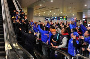 Argentine striker Carlos Tevez, top left, waves as he is escorted away from fans upon arriving at the Pudong International Airport in Shanghai on Thursday Jan. 19, 2017. Shanghai Shenhua has recruited Carlos Tevez and has reportedly made the Argentine the