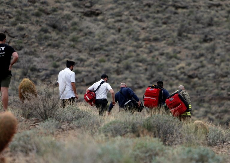 In this Saturday, Feb. 10, 2018, photo, emergency personnel arrive at the scene of a deadly tour helicopter crash along the jagged rocks of the Grand Canyon, in Arizona. (Teddy Fujimoto via AP)