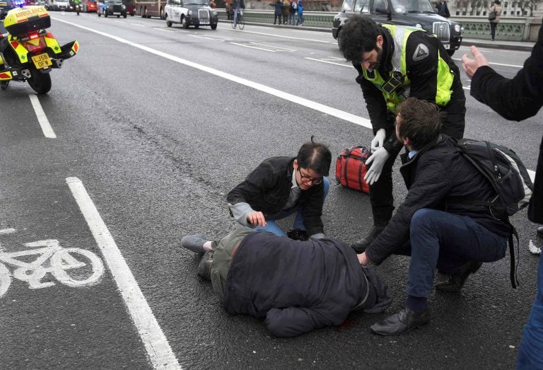 An injured person is assisted after an incident on Westminster Bridge in London, Britain March 22, 2017.  REUTERS/Toby Melville