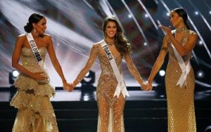 Miss Colombia Andrea Tovar, left, Miss France Iris Mittenaere, center, and Miss Haiti Raquel Pelissier hold hands prior to the announcement of the winner in the Miss Universe 2016 competition Monday, Jan. 30, 2017, at the Mall of Asia in suburban Pasay ci