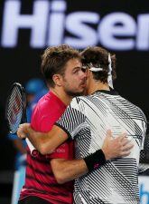 Tennis - Australian Open - Melbourne Park, Melbourne, Australia - 26/1/17 Switzerland's Roger Federer embraces Switzerland's Stan Wawrinka after winning his Men's singles semi-final match. REUTERS/Issei Kato