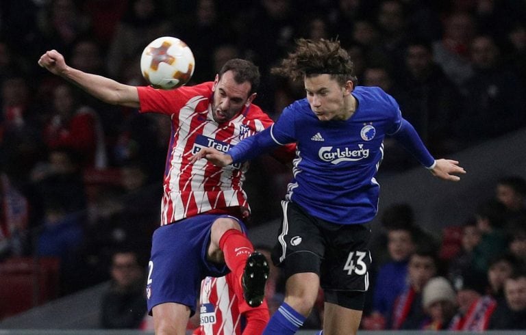 Soccer Football - Europa League Round of 32 Second Leg - Atletico Madrid vs Copenhagen - Wanda Metropolitano, Madrid, Spain - February 22, 2018   Atletico Madrid’s Diego Godin in action with FC Copenhagen’s Jonas Wind    REUTERS/Sergio Perez