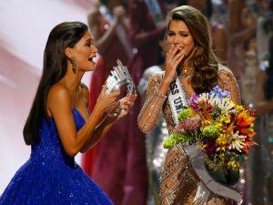 Miss Universe 2015 Pia Wurtzbach, left, of the Philippines rushes to crown Miss France Iris Mittenaere as the Miss Universe 2016 in coronation Monday, Jan. 30, 2017, at the Mall of Asia in suburban Pasay city, south of Manila, Philippines. (AP Photo/Bulli