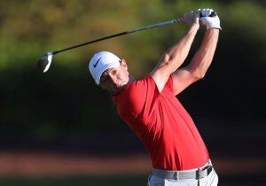 FILE - In this Friday, Nov. 18, 2016 file photo, Rory McIlroy of Northern Ireland plays a shot during the 2nd round of the DP World Tour Championship golf tournament at the Jumeirah Golf Estates in Dubai, United Arab Emirates. Rory McIlroy stayed close to