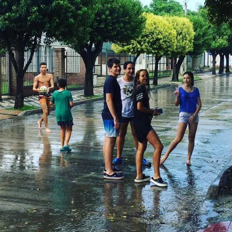 Las fotos de los adolescentes cordobeses jugando bajo la lluvia fueron tomadas por Juan Pablo Rodríguez, en barrio Los Naranjos.