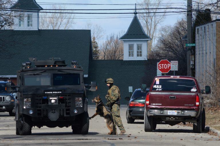 Police search neighborhoods near Central Michigan University for a 19-year-old student suspected of killing his parents at a dormitory and then running from campus, Friday, March 2, 2018 in Mount Pleasant, Mich. (Jacob Hamilton/The Bay City Times via AP)