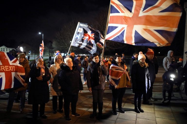 Brexit supporters celebrate during a rally outside Stormont in Belfast, Northern Ireland as Britain left the European Union on Friday, Jan. 31, 2020. Britain officially left the European Union on Friday after a debilitating political period that has bitterly divided the nation since the 2016 Brexit referendum. (AP Photo/Peter Morrison)