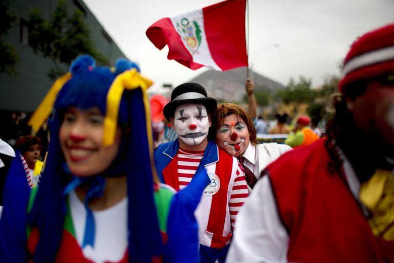 Clowns march while commemorating the Peruvian clown day in Lima Peru, Monday, May 25, 2015. Hundreds of professional clowns dressed in colorful costumes, wigs and face paint marched through the streets of Lima to celebrate Peruvian Clown Day. (AP Photo/Rodrigo Abd) lima peru  dia del payaso peruano festejo festejos celebracion de los payasos gente payasos festejan su dia