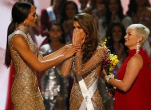 Miss France Iris Mittenaere, center, reacts upon becoming the Miss Universe 2016 as Miss Haiti Raquel Pelissier, left, congratulates her Monday, Jan. 30, 2017, at the Mall of Asia in suburban Pasay city, south of Manila, Philippines. Pelissier was the run