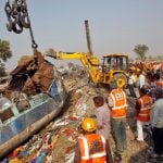 Rescue workers move a carriage at the site of Sunday's train derailment in Pukhrayan, south of Kanpur city, India November 21, 2016. REUTERS/Jitendra Prakash