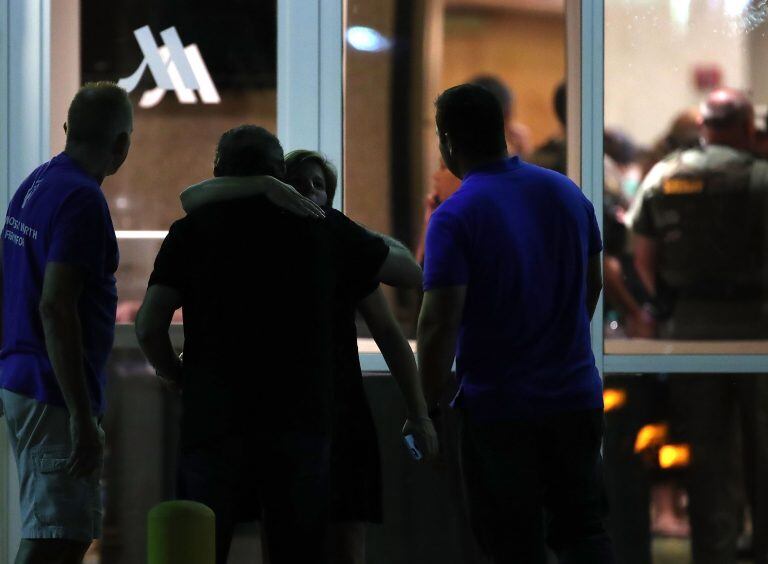 PARKLAND, FL - FEBRUARY 14: People gather at a hotel where students were quickly taken after a mass shooting at the Marjory Stoneman Douglas High School where at least 17 people were killed, on February 14, 2018 in Parkland, Florida. Police arrested the suspect after a short manhunt and have identified him as 19 year old former student Nikolas Cruz.   Mark Wilson/Getty Images/AFP
== FOR NEWSPAPERS, INTERNET, TELCOS & TELEVISION USE ONLY ==