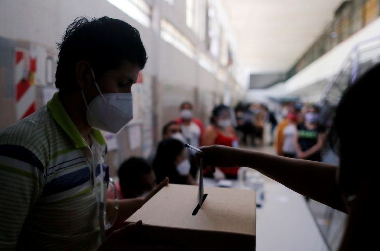 A Bolivian resident living in Argentina casts her vote at a public school in Bolivia's presidential election, as the spread of the coronavirus disease (COVID-19) continues, in Buenos Aires, Argentina October 18, 2020. REUTERS/Agustin Marcarian