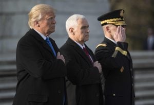 TOPSHOT - US President-elect Donald Trump and Vice President-elect Mike Pence  take part in a wreath-laying ceremony at Arlington National Cemetery in Arlington, Virginia on January 19, 2017. / AFP PHOTO / Mandel Ngan