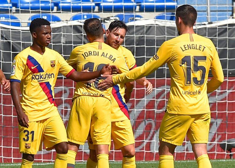 Barcelona's Argentine forward Lionel Messi (2R) celebrates his goal with teammates during the Spanish league football match between Deportivo Alaves and FC Barcelona at the Mendizorroza stadium in Vitoria on July 19, 2020. (Photo by ANDER GILLENEA / AFP)