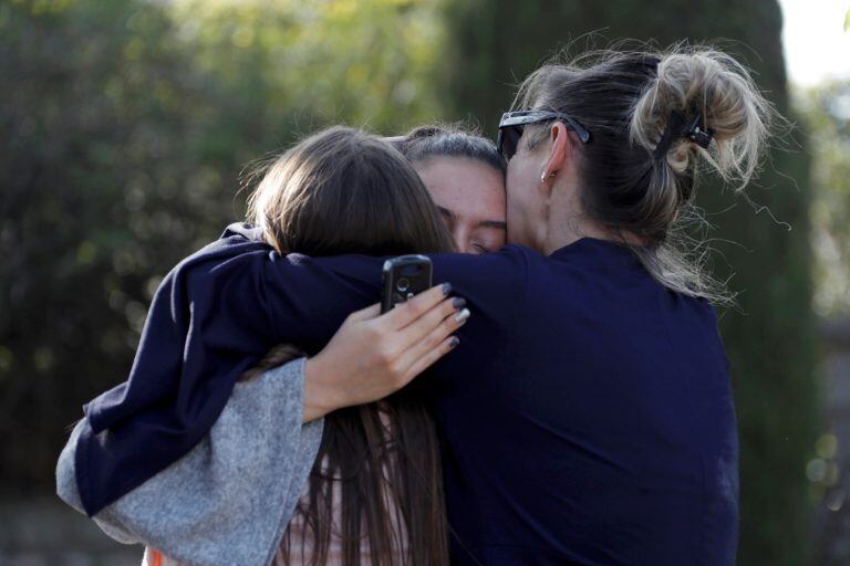 People embrace near the Tocqueville high school after a shooting has taken place injuring at least eight people, in Grasse, southern France, March 16, 2017.    REUTERS/Eric Gaillard TPX IMAGES OF THE DAY