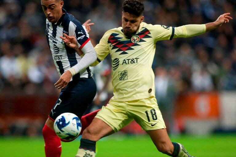 Rogelio Funes Mori (L) of Monterrey vies for the ball with Bruno Valdez of America during their Mexican Clausura 2020 tournament football match at the BBVA Bancomer stadium in Monterrey, Mexico, on February 22, 2020. (Photo by Julio Cesar AGUILAR / AFP)