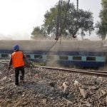 Rescue workers move a carriage at the site of Sunday's train derailment in Pukhrayan, south of Kanpur city, India November 21, 2016. REUTERS/Jitendra Prakash