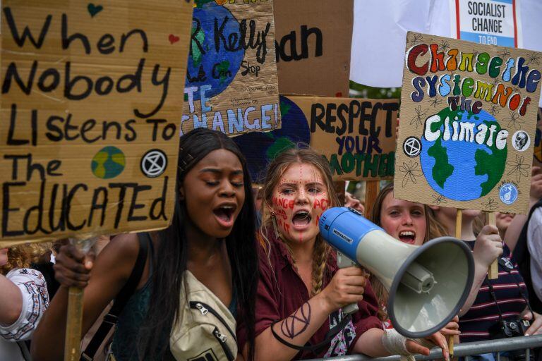 Student climate activists hold banners and shout slogans during a Fridays for Future event near the Houses of Parliament in London, U.K., on Friday, May 24, 2019. On a day when teenagers across the world again mobilized against climate inaction, the movement's icon, Swedish activist Greta Thunberg, said the continent's policy makers -- including environmentalists -- are all failing to heed the climate crisis. Photographer: Chris J. Ratcliffe/Bloomberg