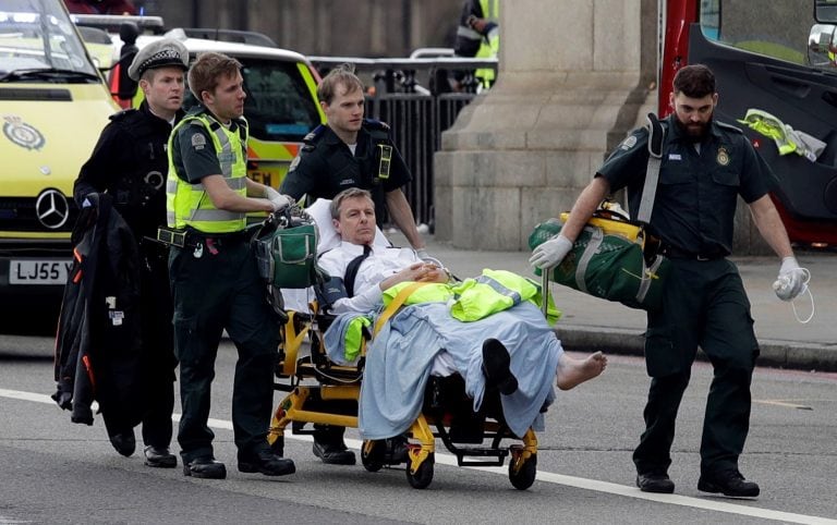 Emergency services transport an injured person to an ambulance, close to the Houses of Parliament in London, Wednesday, March 22, 2017. London police say they are treating a gun and knife incident at Britain's Parliament "as a terrorist incident until we 