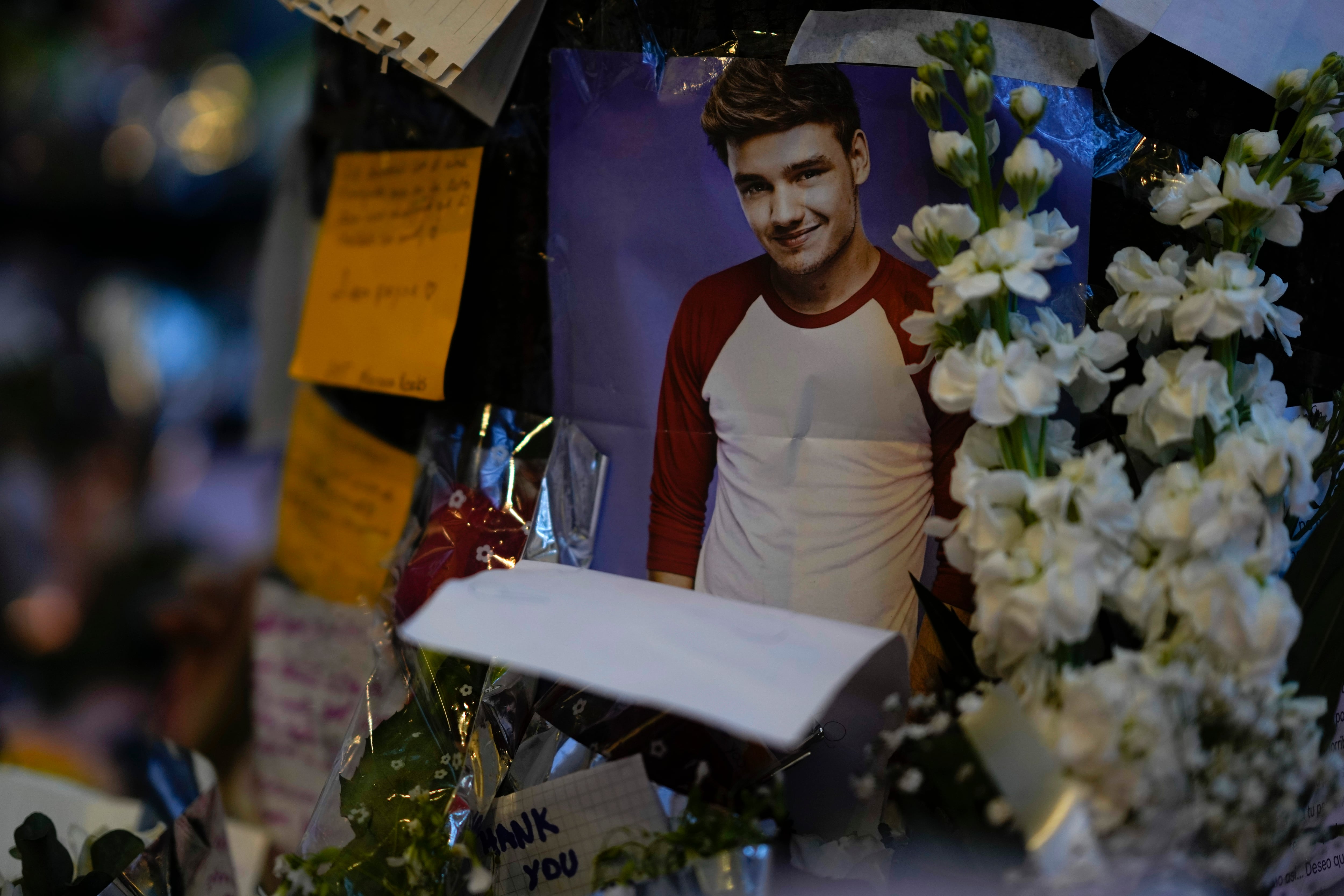 Una foto del excantante de One Direction Liam Payne colocada en un altar improvisado fuera del hotel en el que fue hallado muerto tras caer de un balcón en Buenos Aires, Argentina, el jueves 17 de octubre de 2024. (AP Foto/Natacha Pisarenko)