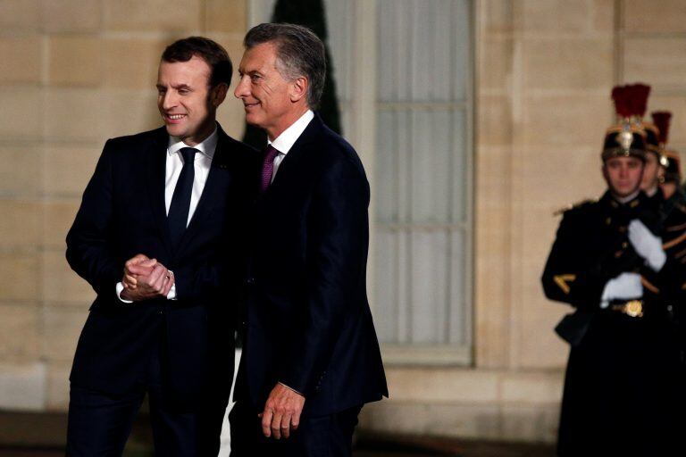 France President Emmanuel Macron, left, welcomes President of Argentina Mauricio Macri prior to a meeting, at the Elysee Palace, in Paris, Friday, Jan. 26, 2018. (AP Photo/Thibault Camus)