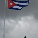 TOPSHOT - An officer remains next to a Cuban flag at half mast following the death of Cuban revolutionary leader Fidel Castro, at the Revolution Square in Havana, on November 27, 2016.
Cuban revolutionary icon Fidel Castro died late November 25 in Havana,